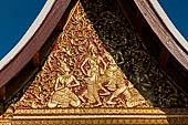 Wat Xieng Thong temple in Luang Prabang, Laos. Detail of the  intricate gilded wood carvings of the gable of the Royal Funerary carriage hall. 